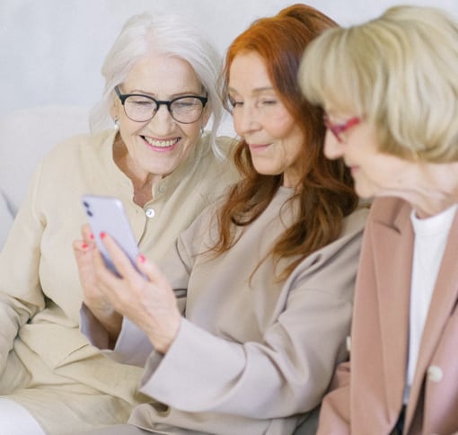 a group of women using their phone to video chat